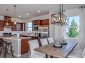 Bright kitchen features stainless appliances, a large island, and seamless flow to dining area at 13740 Rocky Pine Pl, Spring Hill, FL 34610