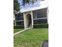 Beautiful condo with a private balcony, manicured lawn, and convenient access to community amenities at 1400 Pine Glen Ln # D2, Tarpon Springs, FL 34688