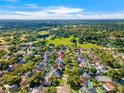 Overhead shot showing lush, green neighborhood with mature trees, pools, and well-maintained houses at 14509 Thornfield Ct, Tampa, FL 33624