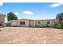 Charming single-story home with brick driveway and well-maintained landscaping at 17444 2Nd E St, Redington Shores, FL 33708