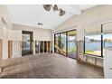 Living room with tile floors and large windows overlooking the water view at 17444 2Nd E St, Redington Shores, FL 33708