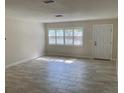 Bright and airy living room with tiled floors, plantation shutters, and a fresh, neutral color palette at 1875 Harmony Dr, Clearwater, FL 33756