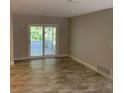 Inviting living area featuring tiled floors and sliding glass doors that open to the outdoor patio at 1875 Harmony Dr, Clearwater, FL 33756