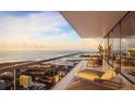 Enjoy breathtaking ocean views from this spacious balcony with elegant outdoor seating and glass railings at 235 1St S Ave # 2405, St Petersburg, FL 33701