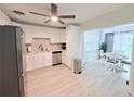 Bright kitchen with white cabinets, stainless steel appliances, and adjacent dining area at 3120 Meadow Lake Ave, Largo, FL 33771