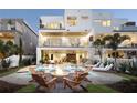 Luxury outdoor living space with a fire pit, pool, and covered patio for relaxing and entertaining at 324 Capri Blvd, Treasure Island, FL 33706