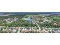 Expansive aerial view of a residential community with lush greenery, ponds, and well-maintained homes at 3409 61St E Ter, Ellenton, FL 34222