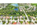 An aerial view of neighborhood homes with a picturesque pond and lush landscaping at 3409 61St E Ter, Ellenton, FL 34222
