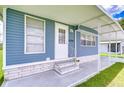 Inviting front porch with stylish accents and covered entrance at 35014 Carl Ave, Zephyrhills, FL 33541