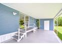 Spacious side porch with outdoor access, perfect for relaxation at 35014 Carl Ave, Zephyrhills, FL 33541
