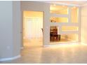 Spacious open-concept living room with tile flooring and a decorative wall feature at 3641 Parkridge Cir # 10-103, Sarasota, FL 34243