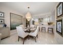Elegant dining room featuring a glass table and chandelier with modern finishes at 4 Belleview Blvd # 305, Belleair, FL 33756