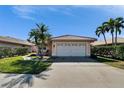 Well-maintained single-Gathering home with a red tile roof, neat landscaping, and attached two-car garage at 4415 Muirfiled Dr, Bradenton, FL 34210