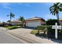 Home featuring a tile roof, neat landscaping, and an attached two-car garage at 4415 Muirfiled Dr, Bradenton, FL 34210
