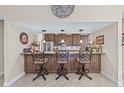 Kitchen bar area with granite countertops and seating for three at 5270 White Sand Ne Cir, St Petersburg, FL 33703