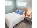Cozy bedroom featuring a tufted headboard bed, soft blue pillows, and stylish décor at 690 Fox St, Longboat Key, FL 34228