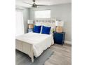 Inviting bedroom with blue accent pillows and contemporary bedside table lamps at 690 Fox St, Longboat Key, FL 34228