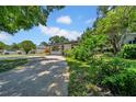 Charming single-story home with lush landscaping and a concrete driveway at 762 77Th N Ave, St Petersburg, FL 33702