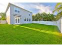 Spacious backyard features lush green grass and a privacy fence, perfect for outdoor activities at 7703 S West Shore Blvd, Tampa, FL 33616