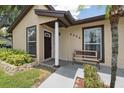 Charming front porch with stylish bench seating and updated exterior at 8306 N Gomez Ave, Tampa, FL 33614