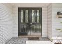 Close up of a black double front door with decorative glass inserts and a 'Welcome' mat at 8500 144Th Ln, Seminole, FL 33776
