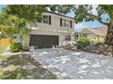 Two-story home with a two-car garage and a long driveway, enhanced with a brick trim at 8500 144Th Ln, Seminole, FL 33776