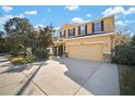 Inviting front exterior showcasing a well-maintained lawn and two-car garage at 8607 Tidal Breeze Dr, Riverview, FL 33569