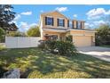 Beautifully landscaped front yard featuring lush green grass surrounding a charming home at 8607 Tidal Breeze Dr, Riverview, FL 33569