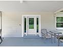 Cozy front porch with neutral paint, a white door, and comfortable seating, perfect for relaxing outdoors at 9413 Forest Hills Dr, Tampa, FL 33612
