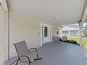 Neutral painted porch with outdoor seating, ideal for enjoying quiet moments and neighborhood views at 9413 Forest Hills Dr, Tampa, FL 33612