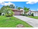 Charming single-story home features a well-manicured lawn, landscaping, and a driveway at 10732 Drummond Rd, Tampa, FL 33615