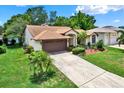 Charming single-story home features a well-manicured lawn, landscaping, and a driveway at 10732 Drummond Rd, Tampa, FL 33615