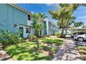 Inviting townhome exterior with lush green lawn, sidewalks, and convenient parking at 110 114Th Ne Ter # 110, St Petersburg, FL 33716