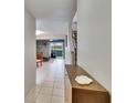 Bright hallway featuring tile floors, staircase, and view into the living area at 110 114Th Ne Ter # 110, St Petersburg, FL 33716