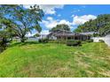 Expansive backyard featuring a screened-in pool area and well-maintained landscaping at 11250 Tradewinds Blvd, Largo, FL 33773