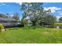 Lush backyard with green grass and mature trees provides privacy and serenity at 11250 Tradewinds Blvd, Largo, FL 33773