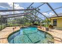 Sparkling screened-in pool with brick surround offers a relaxing outdoor oasis at 11250 Tradewinds Blvd, Largo, FL 33773