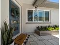 Inviting front entrance with a stylish blue door, decorative wreath, and a welcoming 