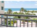 Enjoy stunning ocean views from this condo's balcony overlooking lush landscaping, palm trees, and a sparkling beach at 1180 Gulf Blvd # 504, Clearwater Beach, FL 33767