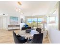Bright dining area featuring a marble table, stylish decor, and panoramic ocean views through large windows at 1180 Gulf Blvd # 504, Clearwater Beach, FL 33767