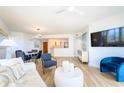 Inviting living room with hardwood floors, modern furniture, a flat-screen TV, and seamless flow to the kitchen at 1180 Gulf Blvd # 504, Clearwater Beach, FL 33767