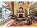 Elegant living room featuring a fireplace, high ceilings, and water view at 12125 Stonelake Ranch Blvd, Thonotosassa, FL 33592