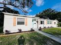 Charming home featuring a bright exterior, complemented by neat landscaping and decorative window shutters at 1300 21St S St, St Petersburg, FL 33712