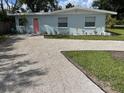Attractive single-story home with a newly paved driveway and updated landscaping, complemented by a light blue exterior at 1407 Coral Ridge Dr, Punta Gorda, FL 33950