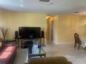 Spacious living area with a TV and entertainment setup with access to an adjacent dining area at 1480 Fairfield Dr, Clearwater, FL 33764