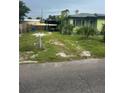 Cozy home with a carport, partially fenced front yard, and potential for landscaping upgrades at 1557 15Th S St, St Petersburg, FL 33705