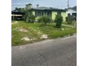 Quaint single-Gathering home features a carport, mature landscaping, and a cozy front entrance at 1557 15Th S St, St Petersburg, FL 33705