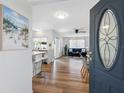 Warm and inviting living spaces with wood floors, a modern kitchen, and a comfortable living room at 1675 E Grovehill Rd, Palm Harbor, FL 34683