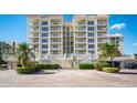 Stunning beachfront condo with elegant architecture, a grand staircase, and lush landscaping, offering luxurious coastal living at 17720 Gulf Blvd # A702, Redington Shores, FL 33708