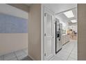 Bright hallway featuring tile flooring, neutral paint colors and easy access to the kitchen and pantry at 1811 49Th N St, St Petersburg, FL 33710